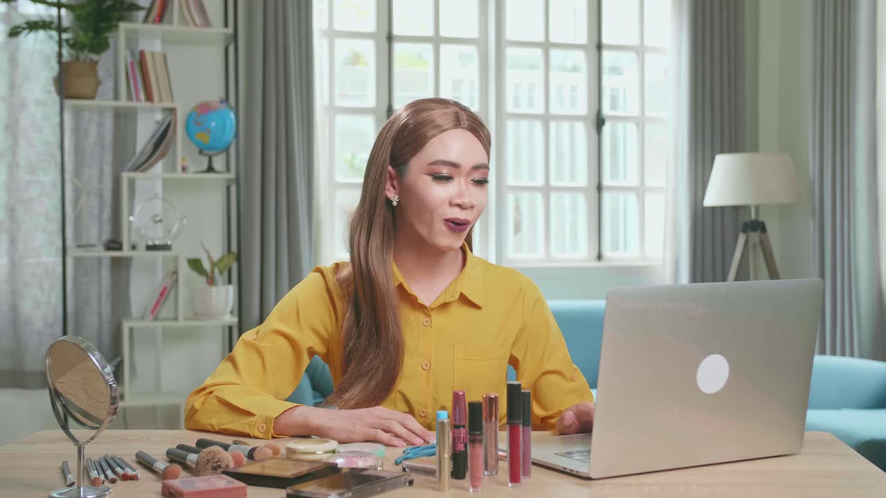 Influencer Young Transgender Woman Blogger Read Comment On Laptop Computer. Vlogger Tells How To Be Beautiful In Home Studio