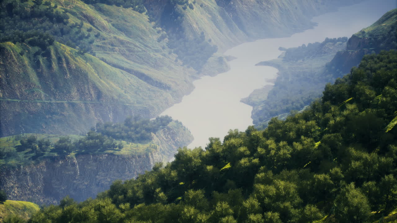 Majestic river winds through lush mountains during serene daylight hours