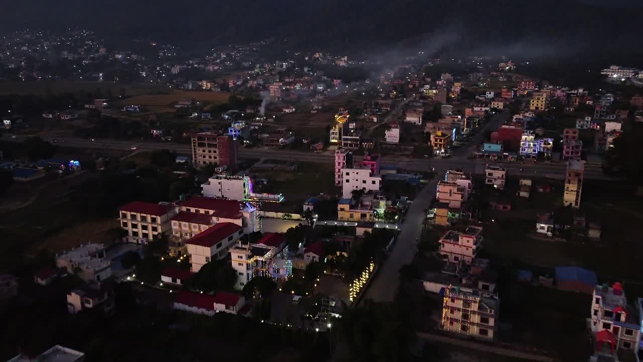 A low level aerial over the city of Surkhet, Nepal in the late evening ...