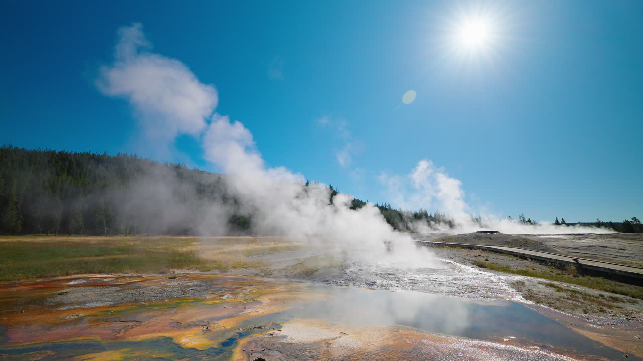 Steam rising from colorful hot springs in Yellowstone National Park