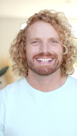 vertical video of portrait of happy caucasian man at home in slow motion
