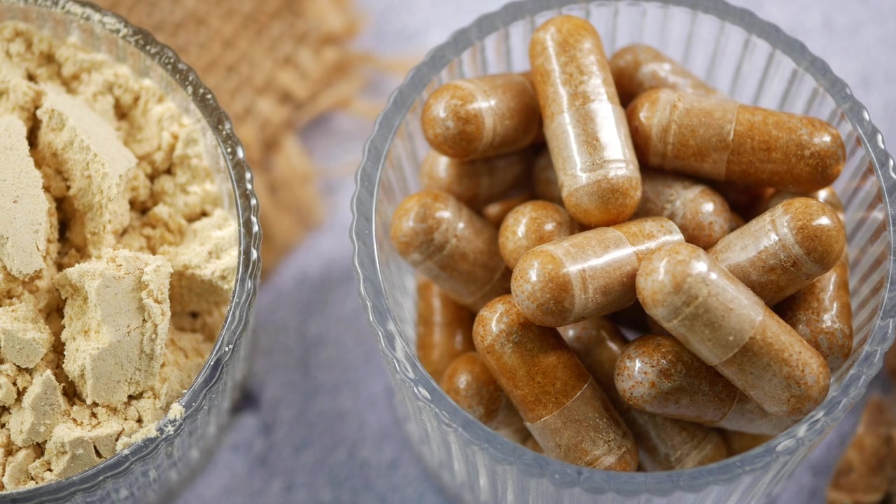 Herbal Supplement Capsules and Powder in Bowls