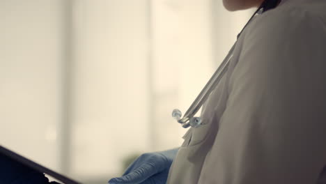 woman doctor collecting medical history senior patient using tablet close up.