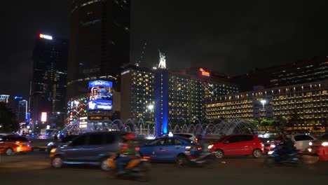 night illumination jakarta city downtown famous traffic street circle fountain panorama 4k indonesia