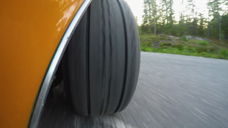 4k close-up of a retro car wheel while driving on a road