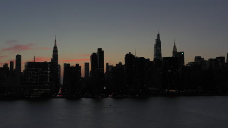 quick diagonal aerial flight toward manhattan at gorgeous twilight sunset