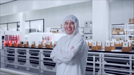 side view of asian male scientist crossing his arms and smiling with conveyor for packaging coffee beans in bags at coffee factory