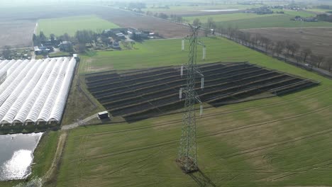 Aerial View of Energy Infrastructure and Greenhouses in a Rural Landscape