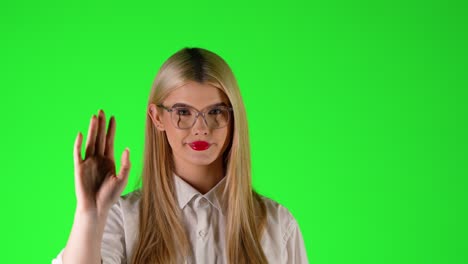 close-up blonde woman with red lipstick waves goodbye, isolated green screen