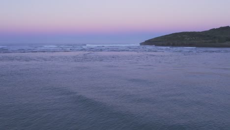 sunset over bay of biscay from secluded sandy beach playa de la arena aerial