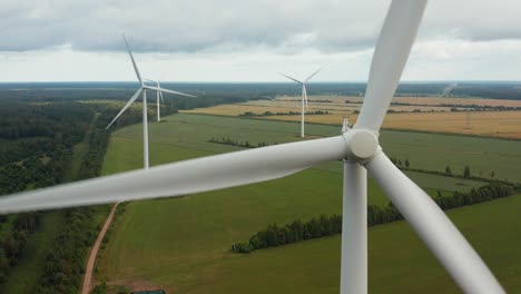 close up of a rotating wind turbine with wind turbine park in the background