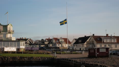 swedish flag swaying at gentle breeze at molle locality in hoganas, skane county, sweden