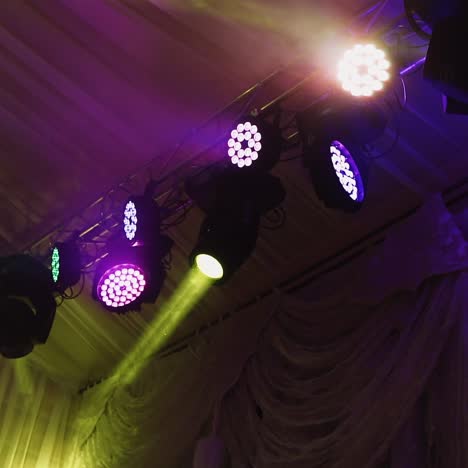 lights flashing on the ceiling of a nightclub. colorful spotlights spinning and glittering during the dance party.