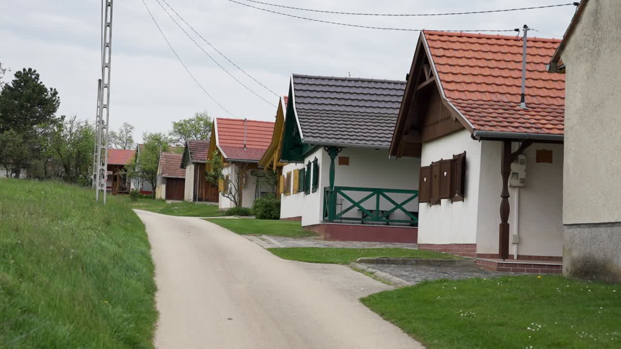Row of colorful small village houses along a quiet rural street