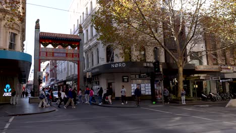 people crossing street, tram passing by