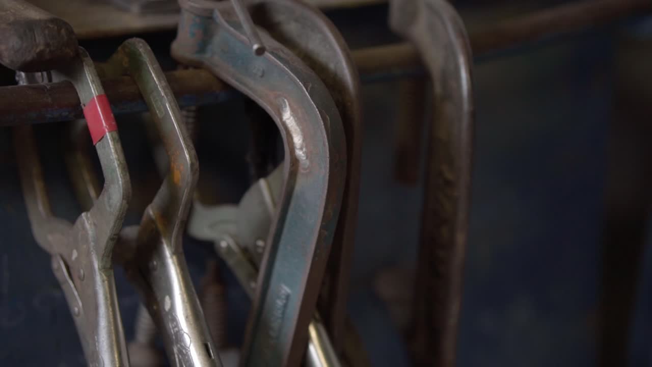 Welder's Tools Hanging in a Rustic Garage, Close-up of Vise Grip Clamps