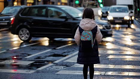 child crossing a busy city street