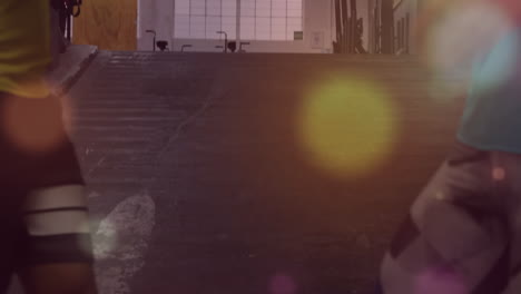 animation of lens flares over caucasian man and woman walking and running on slope in gym