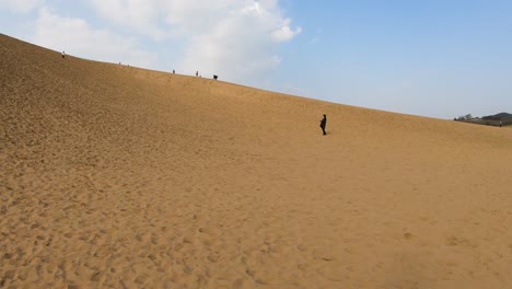 tourists exploring tottori sand dunes in rural japan
