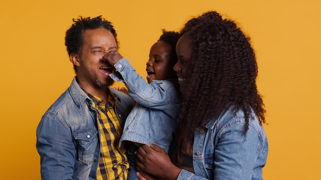 Portrait of african american family with a small boy posing in studio
