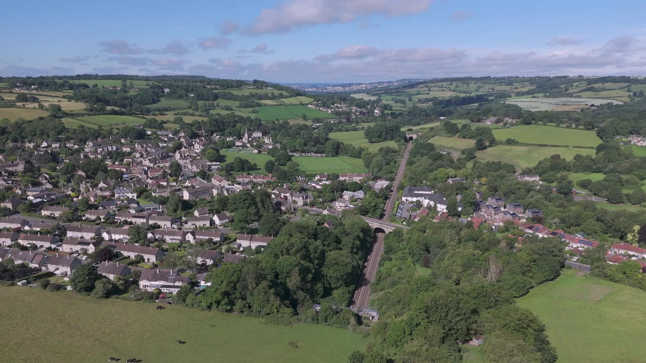 Orbita aerea parziale del villaggio di Box, Wiltshire, che si concentra sul suo tunnel ferroviario in una giornata estiva
