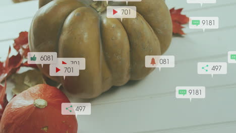 social media interaction icons animation over autumn pumpkins and leaves on white surface