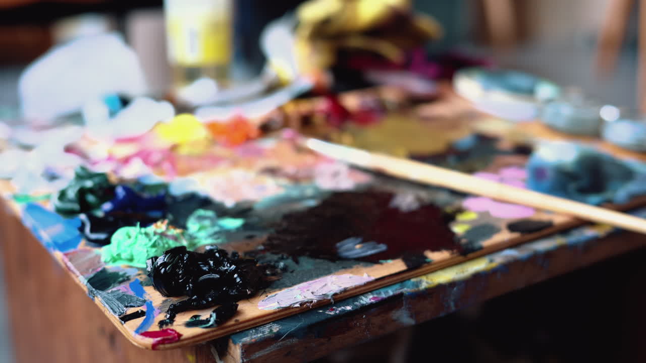 Close up of different colours of paint on a palette