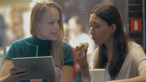 good friend sharing tasty cake in cafe