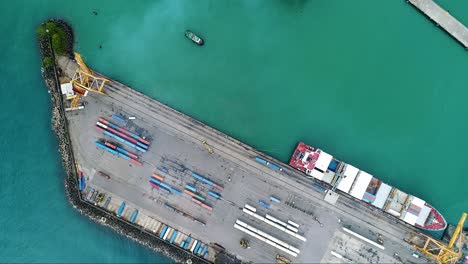 intermodal containers and cargo ship at the container terminal of puerto limon in costa rica