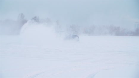 car drifting in a snowstorm