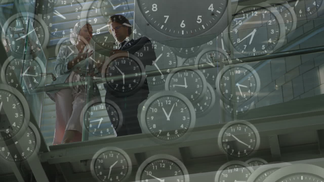 Clocks animation over business people discussing in modern office building