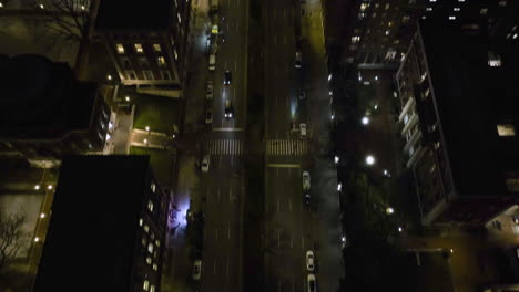 Aerial-view-tilting-over-the-illuminated-Broadway-street,-night-in-Morningside-heights,-New-York,-USA