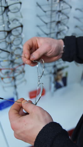 person trying on eyeglasses in an optical shop