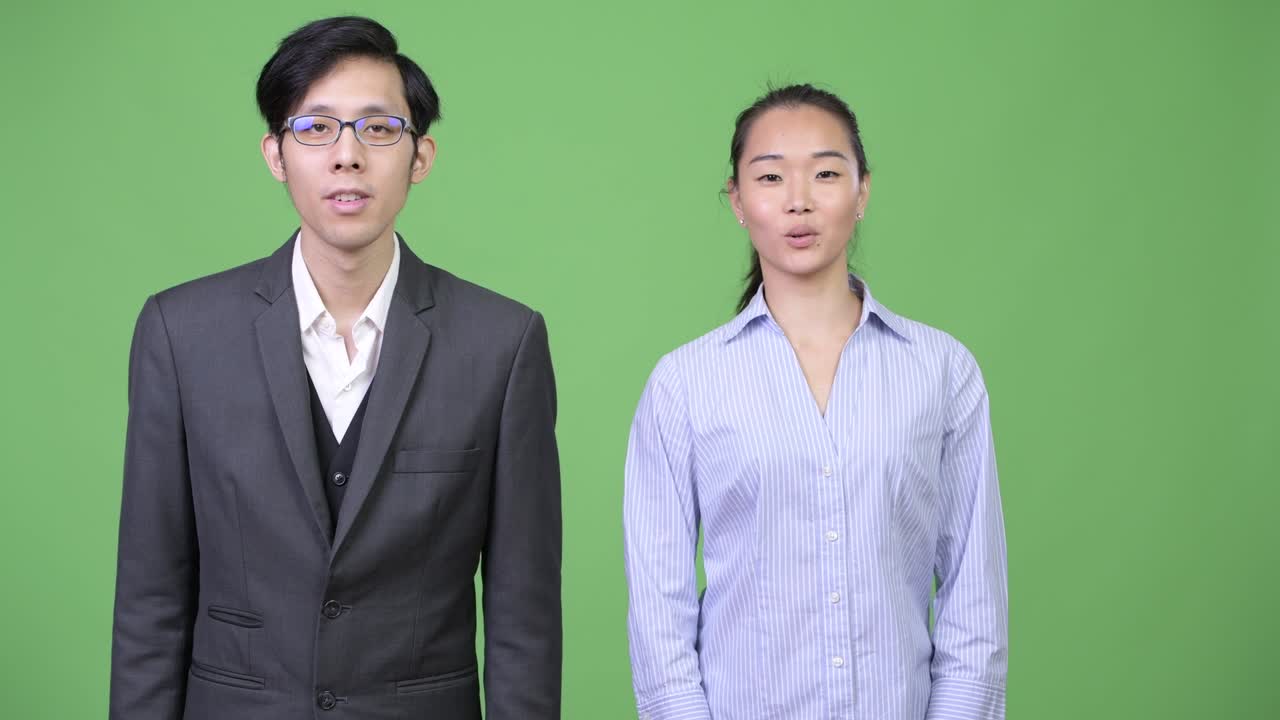 Young Asian business couple talking together