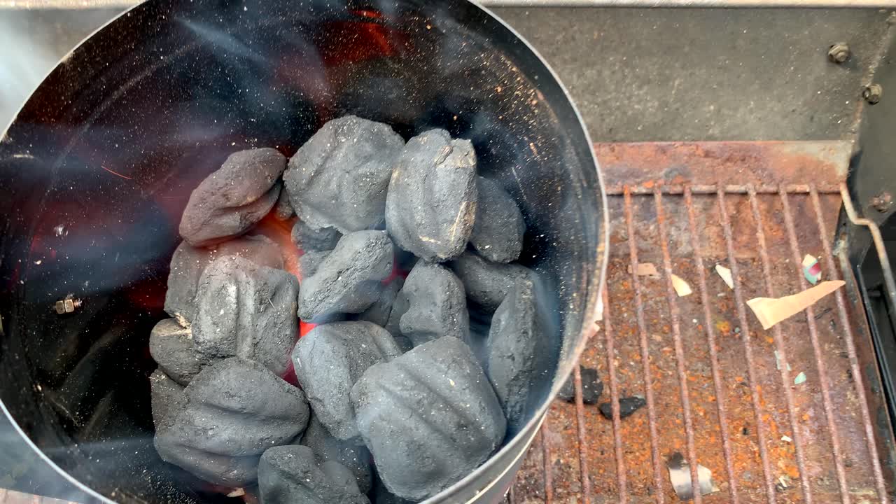 Lit coal with chimney coal starter, close up, no person