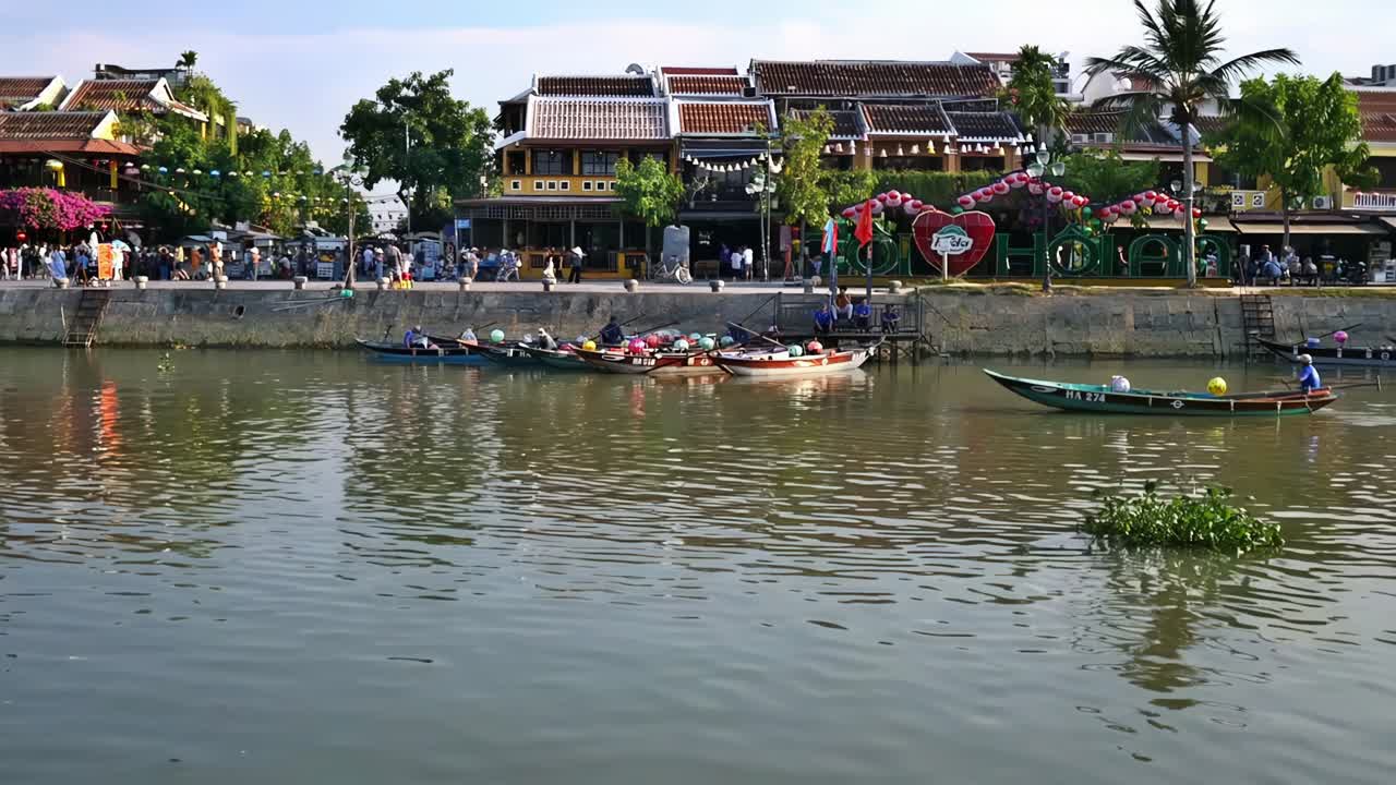 Rowboats on the scenic Thu Bon River at a section of the Old Quarter in the city of Hoi An, Vietnam.