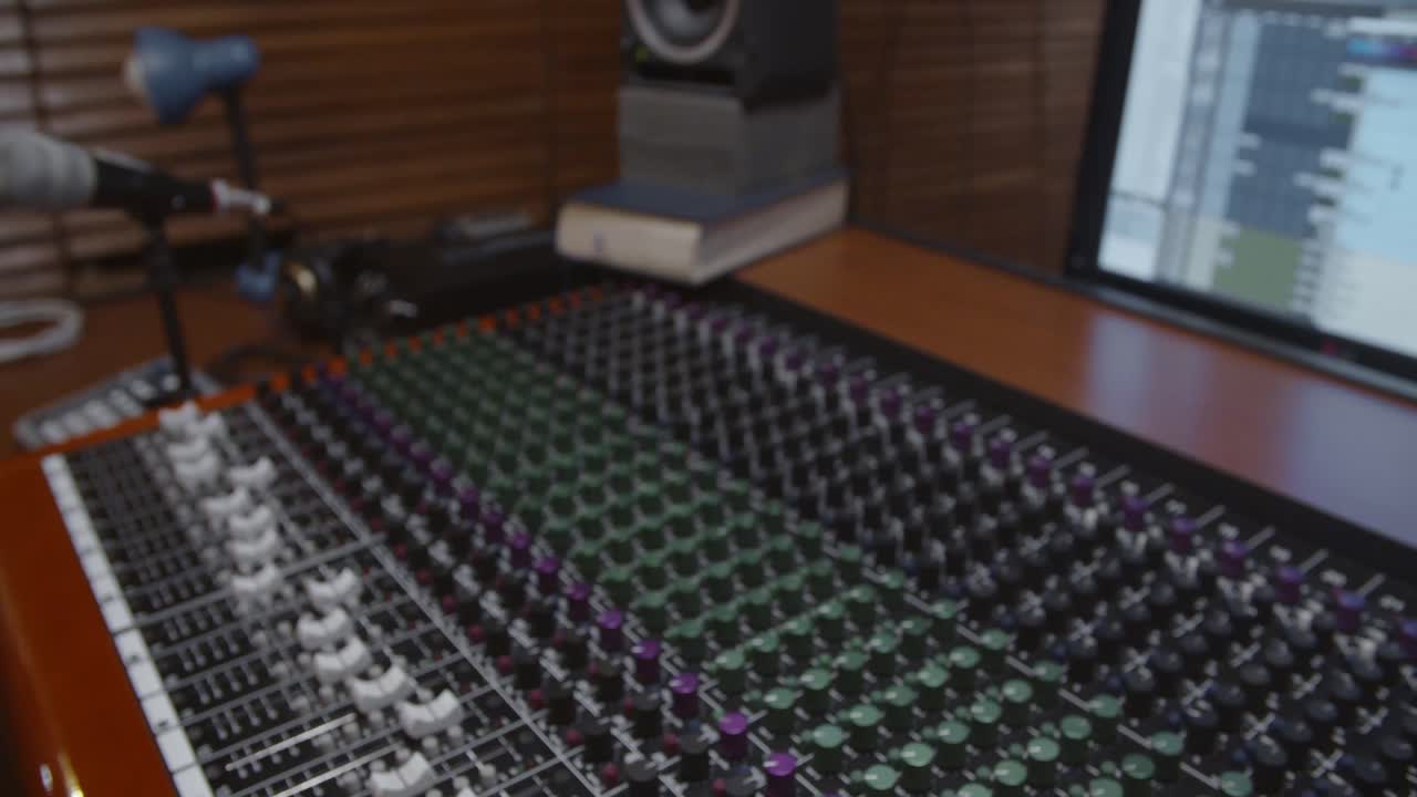Man in a control room of a recording studio moving a fader with a Toft console - Professional recording studio - 4K at 60fps (slowmotion) - Professional audio vives