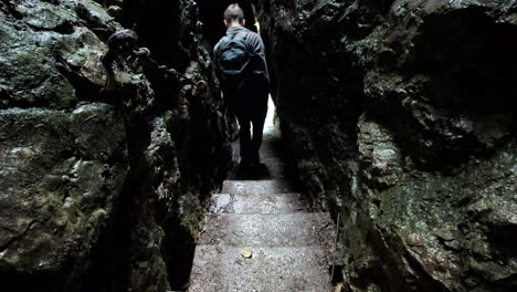 man walking through pokljuka gorge in slovenia during spring in the triglav national park