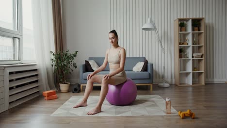 woman sitting on exercise ball in home gym