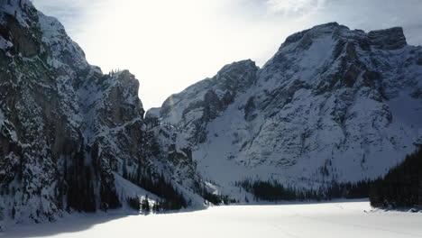 Montañas-Nevadas-De-Dolomitas-Y-Lago-Congelado-Braies-Vista-Aérea-Escénica