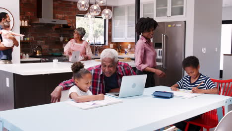 children doing homework in busy multi generation family home