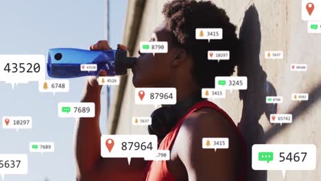 Animation-of-notification-icons-and-changing-numbers-over-african-american-athlete-drinking-water