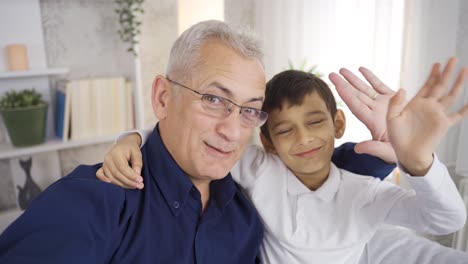 father and son talking on the phone together at home.