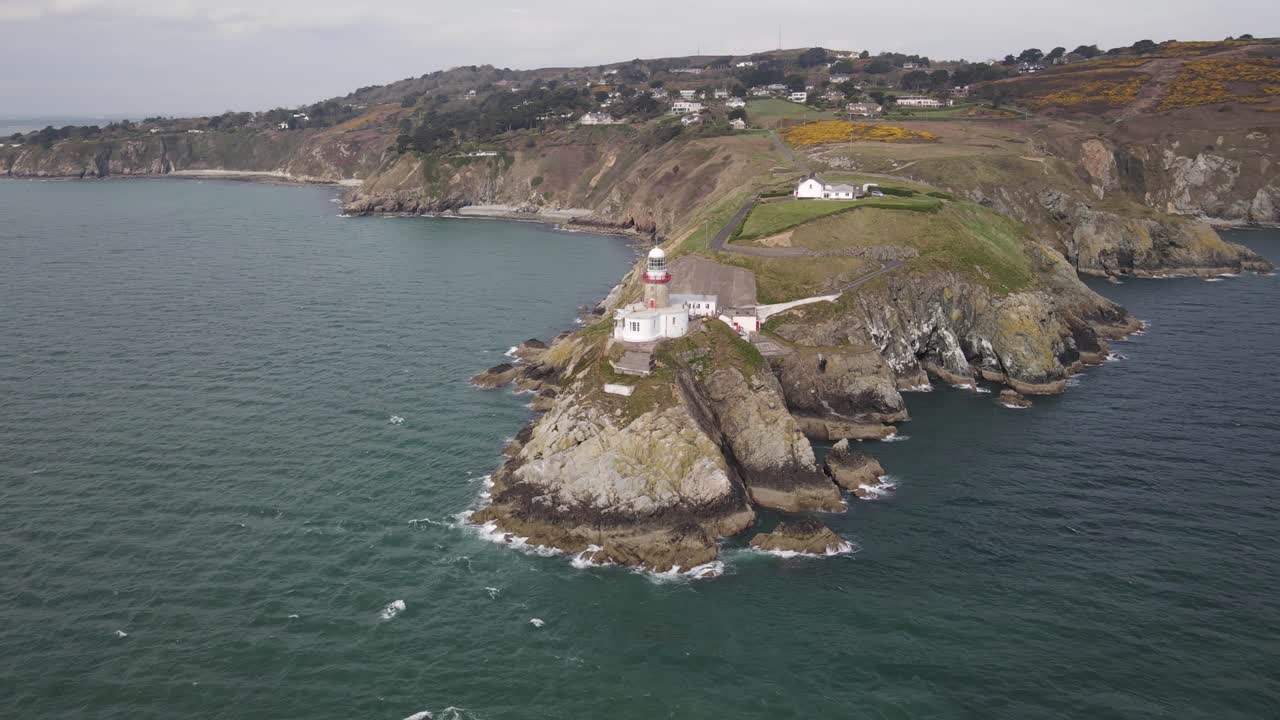 faro de baily en howth head, bahía de dublín irlanda - toma aérea de drones