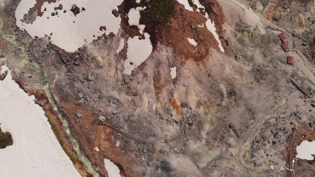 Aerial Tops down smoking Tamagawa Onsen Resort, Geothermal Steam in Akita Japan