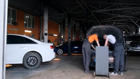mechanics working on a car in an auto repair shop