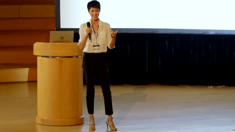 young asian businesswoman speaking in speaker on stage in auditorium 4k