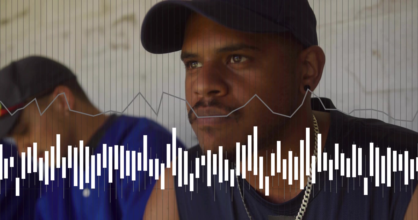 Front man sitting watching offframe while teammate shifting, audio cue starting waveform for sports