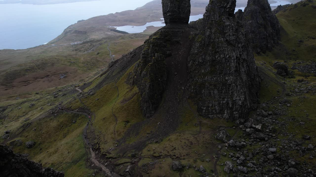 Dramatic tilt up reveal aerial shot of the man of Storr mountains on the isle of Skye