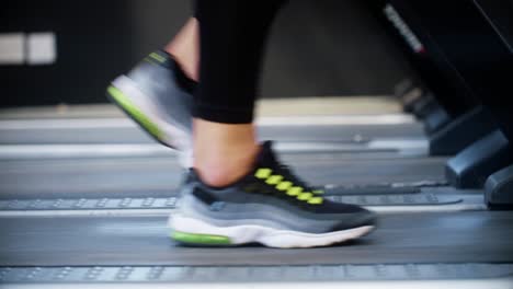 side on shot of person training on treadmill